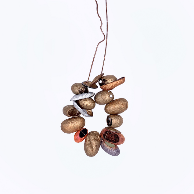 Rose gold necklace with 12 threaded silk cocoons open at the front, painted in bronze colours on the outside and various glitter pigments on the inside