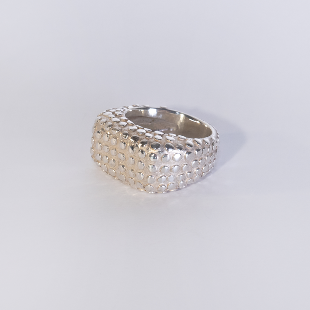 Wide heavy silver ring with polished flat nubs surface