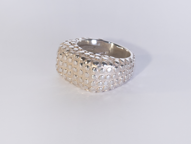 Wide heavy silver ring with polished flat nubs surface