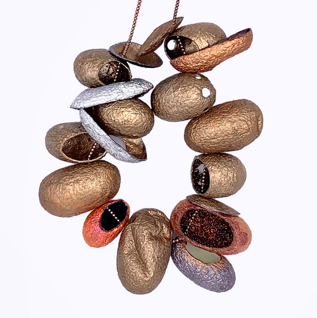 Rose gold necklace with 12 threaded silk cocoons open at the front, painted in bronze colours on the outside and various glitter pigments on the inside