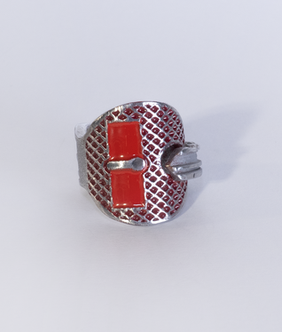 Aluminium key bent into a ring, two rectangular areas and the structured surface are filled with red enamel