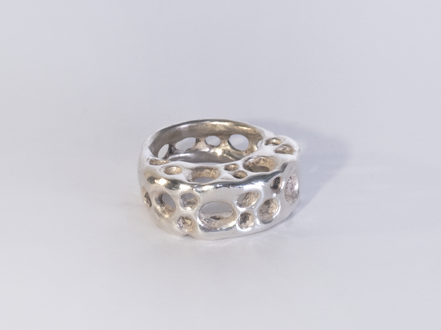 Silver ring with a hole structure that looks like cheese