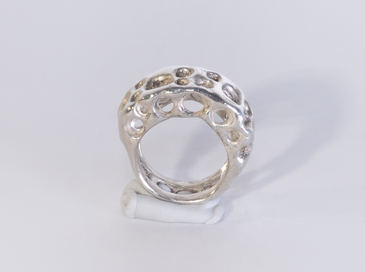 Silver ring with a hole structure that looks like cheese