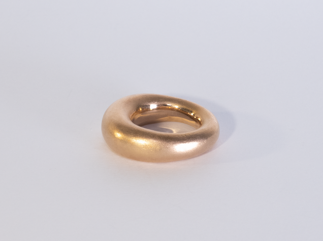 Golden heavy ring thicker at the top edge than at the bottom
