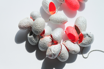 Long necklace made of 21 silk cocoons, bright orange inside, silver-coloured outside, on a thin stainless steel chain