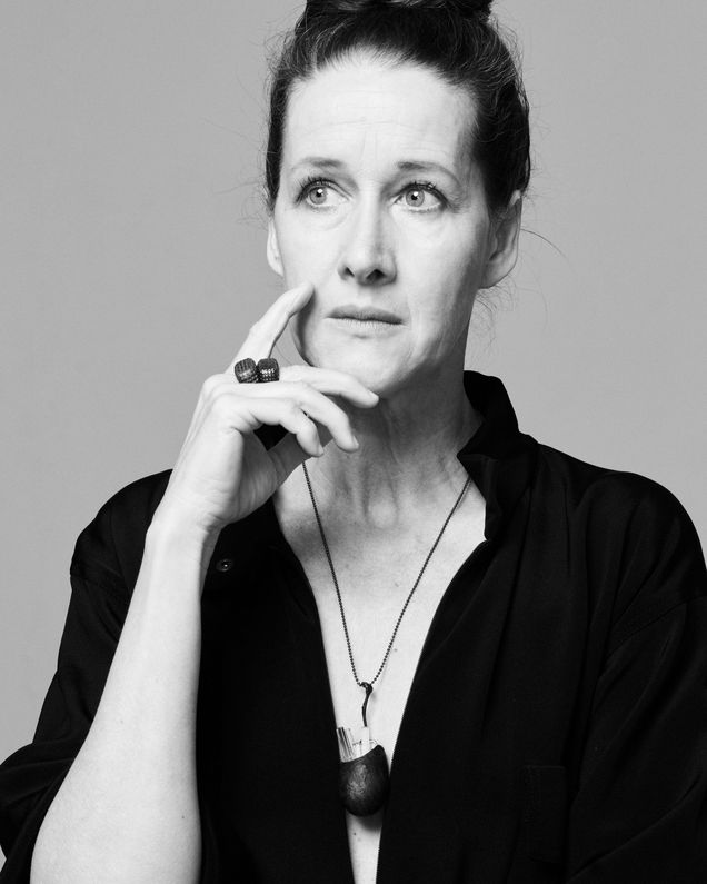 Actress Sabine Haupt with a black dress, necklace with black pendant and a ring, she looks thoughtful