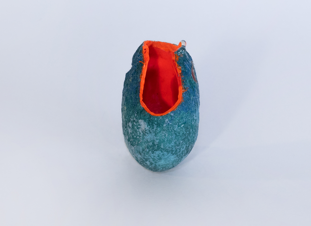 Pendant made of an open dark green silk cocoon, painted bright orange on the inside, on the outside are shiny drops