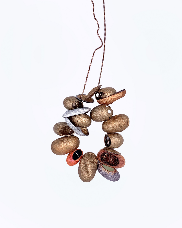 Rose gold necklace with 12 threaded silk cocoons open at the front, painted in bronze colours on the outside and various glitter pigments on the inside
