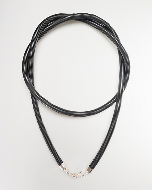 Long necklace made of black protective tube with cast silver clasps