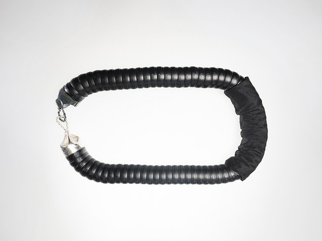 Heavy chain in black flexible industrial hose with cast silver clasps and silk fabric