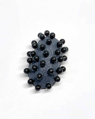 Open silver silk cocoon, pierced with many flat black pins, on a black silver chain