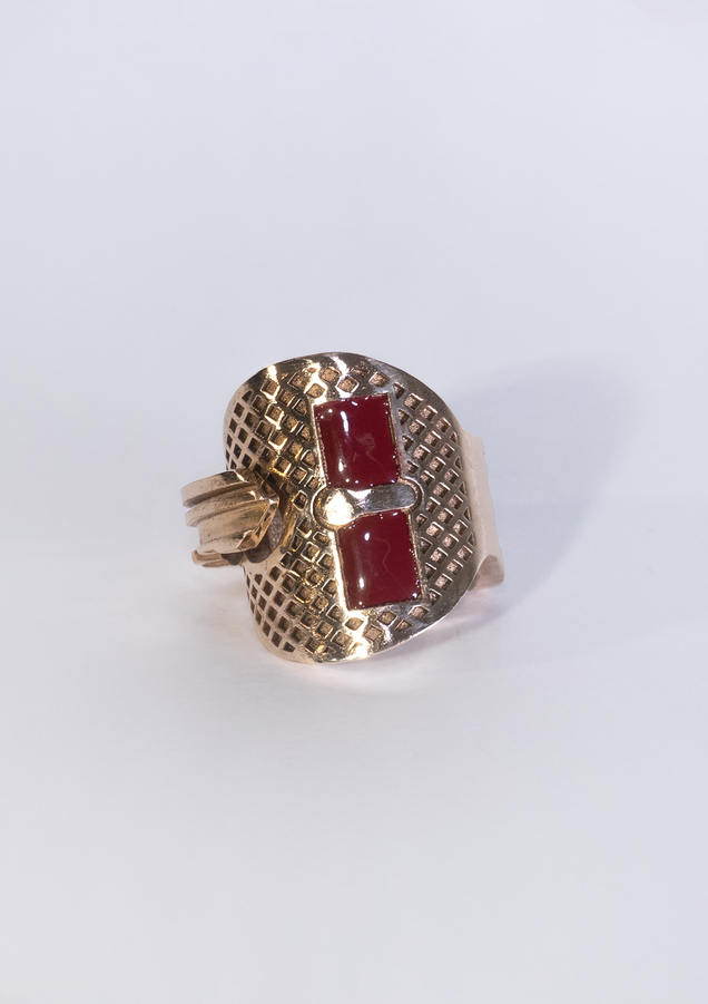 Bronze key bent into a ring, two rectangular areas are filled with red enamel