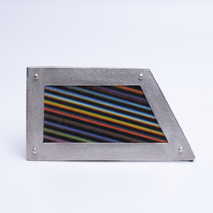 Irregular angular brooch with a silver frame and canvas in colourful fine stripes, it looks like a framed picture