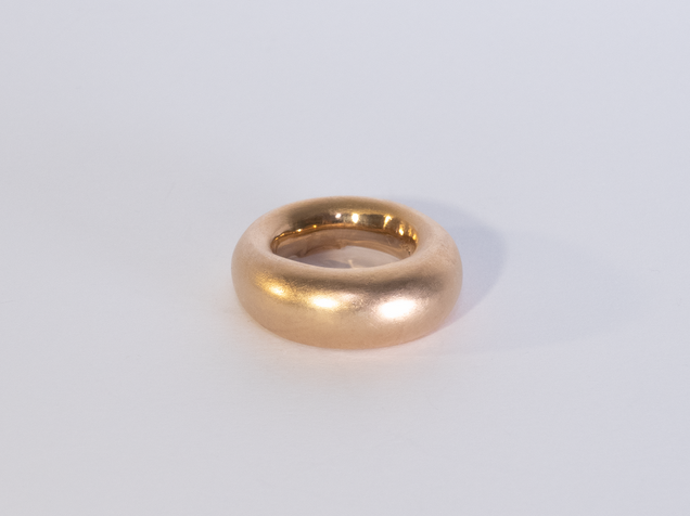 Golden heavy ring thicker at the top edge than at the bottom