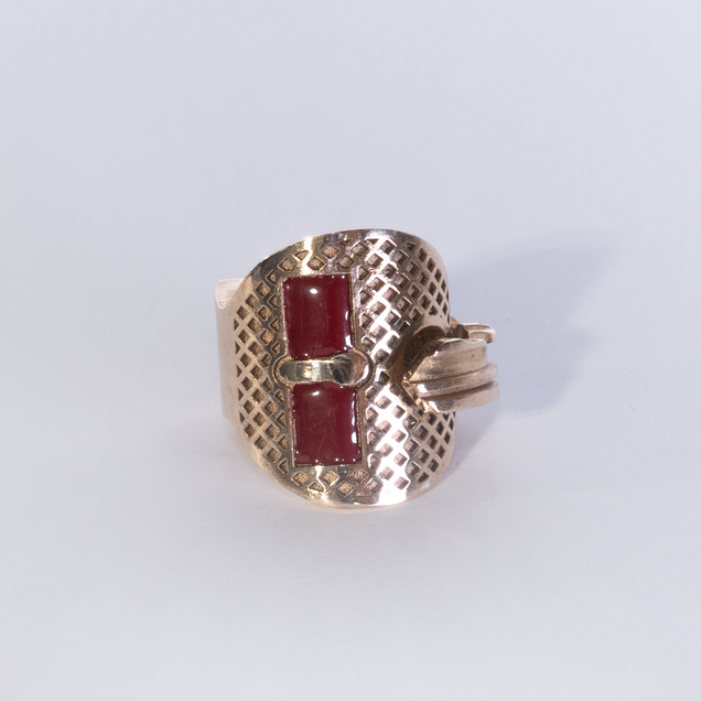 Bronze key bent into a ring, two rectangular areas are filled with red enamel