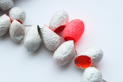 Long necklace made of 21 silk cocoons, bright orange inside, silver-coloured outside, on a thin stainless steel chain