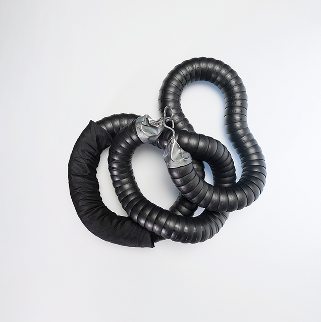 Heavy chain in black flexible industrial hose with cast silver clasps and silk fabric