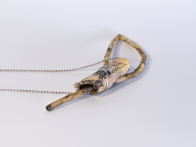 Necklace with a sling pendant made from tube, that looks like yellowish bamboo