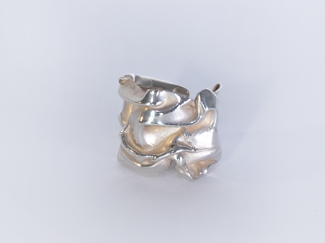 Curved open silver ring with that looks like a thick crushed foil